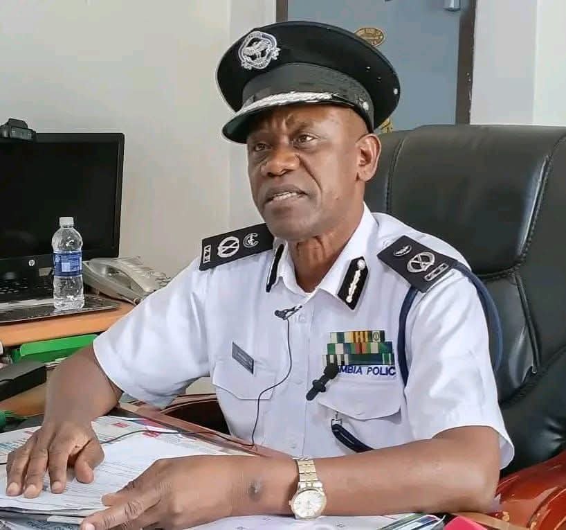 Police officers at a rural scene in Eastern Province, Zambia, with an ambulance and investigator clipboard